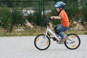 boy riding bike in a helmet