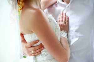 Bride And Groom On Their Wedding Day Hugging