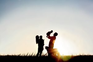 Silhouette Of Happy Family And Dog