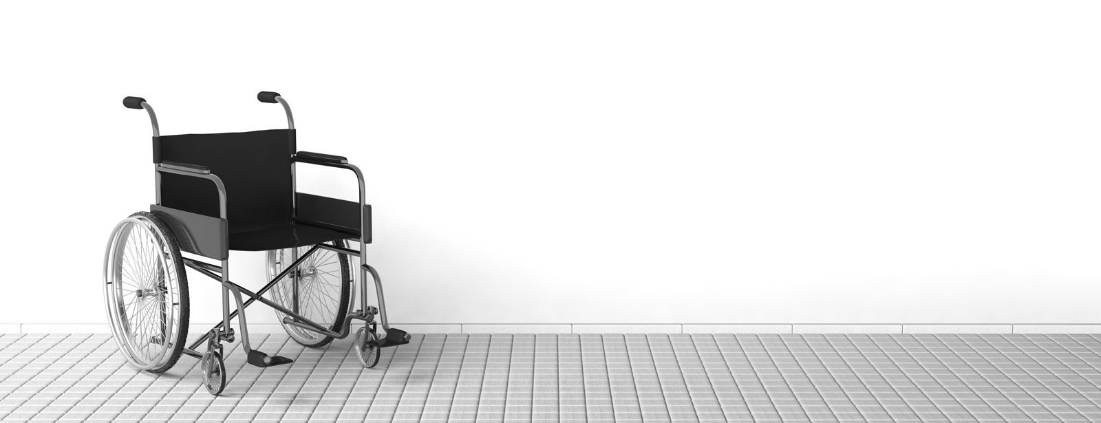 Black disability wheelchair near clean white wall