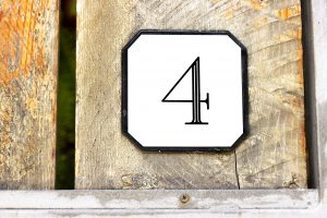 Number 4 on textured wooden wall